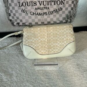 Coach wristlet tan with cream, leather trim, and strap